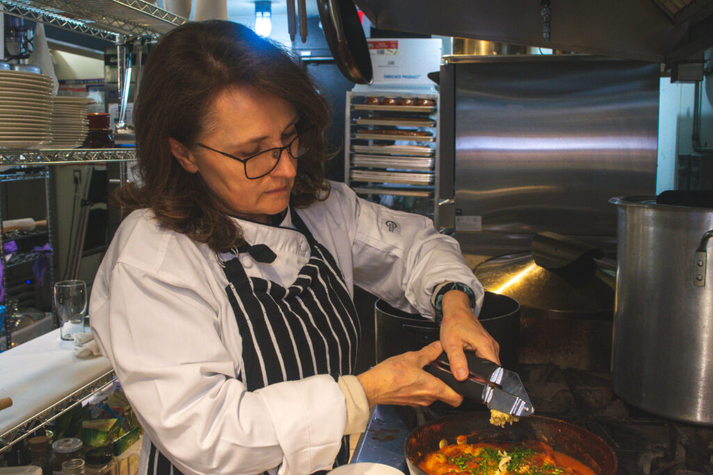 Russian chef Elena DeYoung prepares cultural food in kitchen