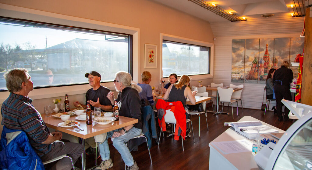Guests enjoying a relaxed dinner and conversation inside Alyonka Russian Cuisine in Boise