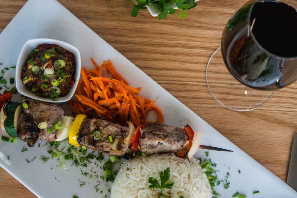Plated shashlik with glass of red wine