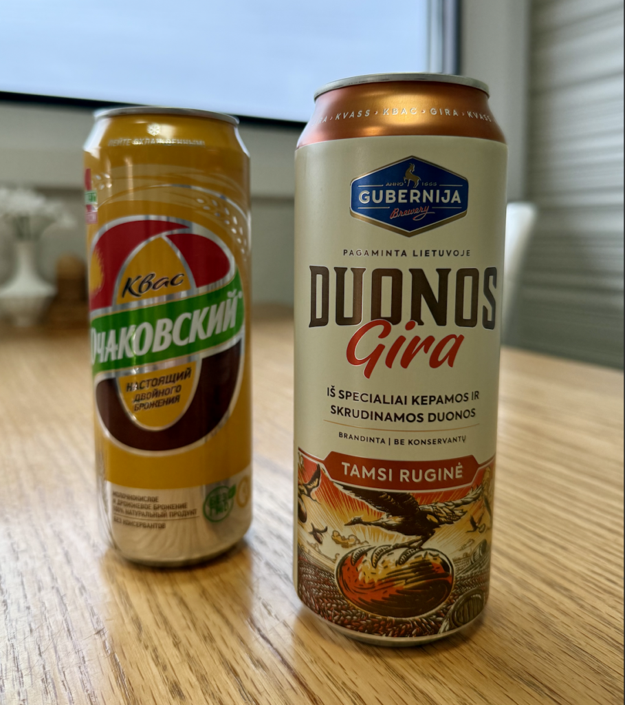 two cans of kvass on table